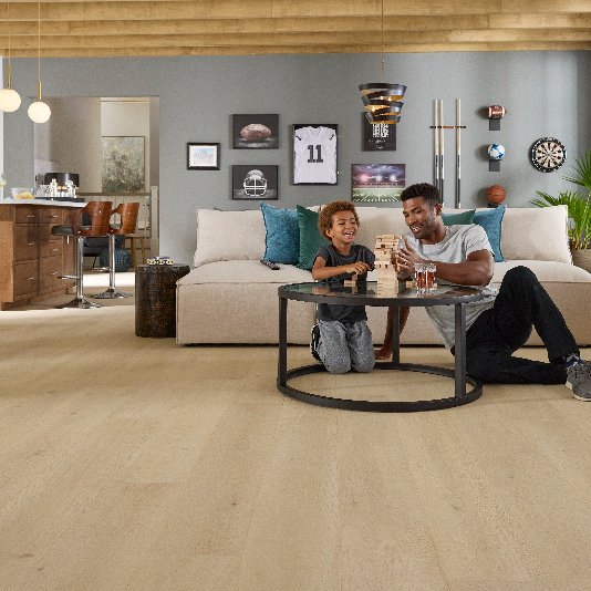 Father and son in an open rec room with durable Pergo flooring